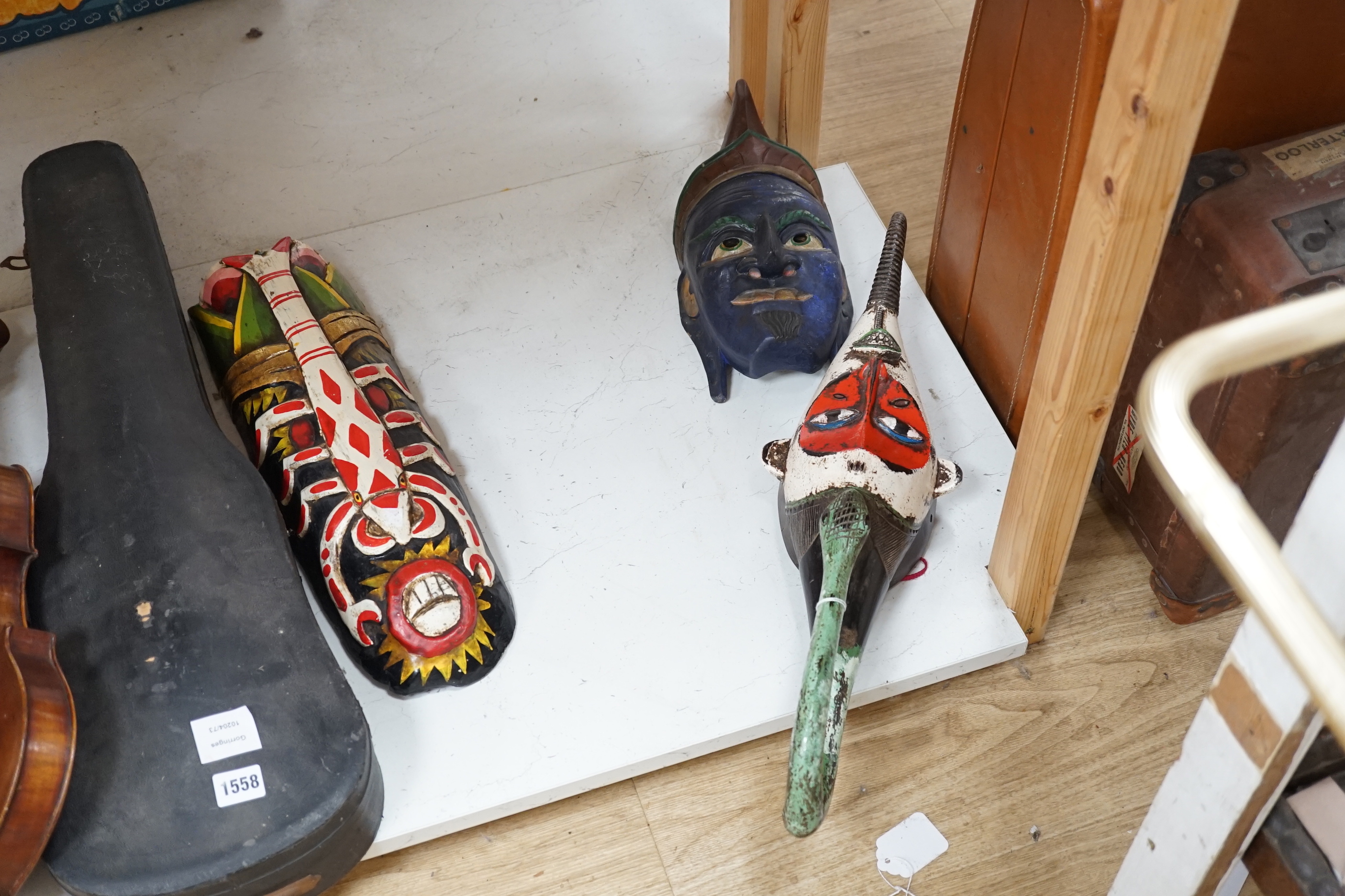 Six Indonesian tribal painted wood masks, largest 60cm high